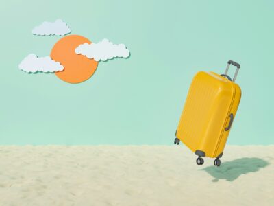 a yellow suitcase on sand