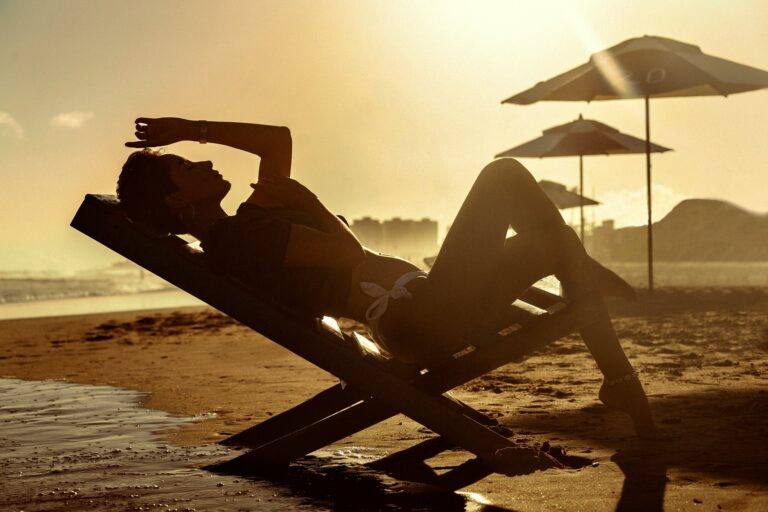 A woman lying on a chair on a beach