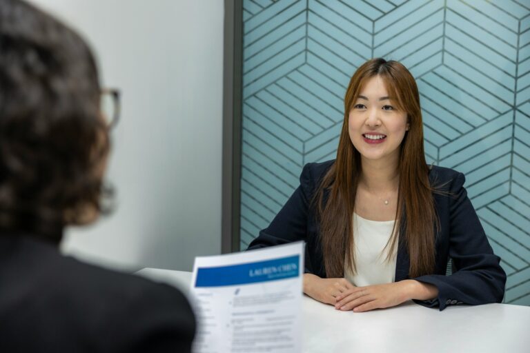 A woman sitting at a table with a woman in front of her
