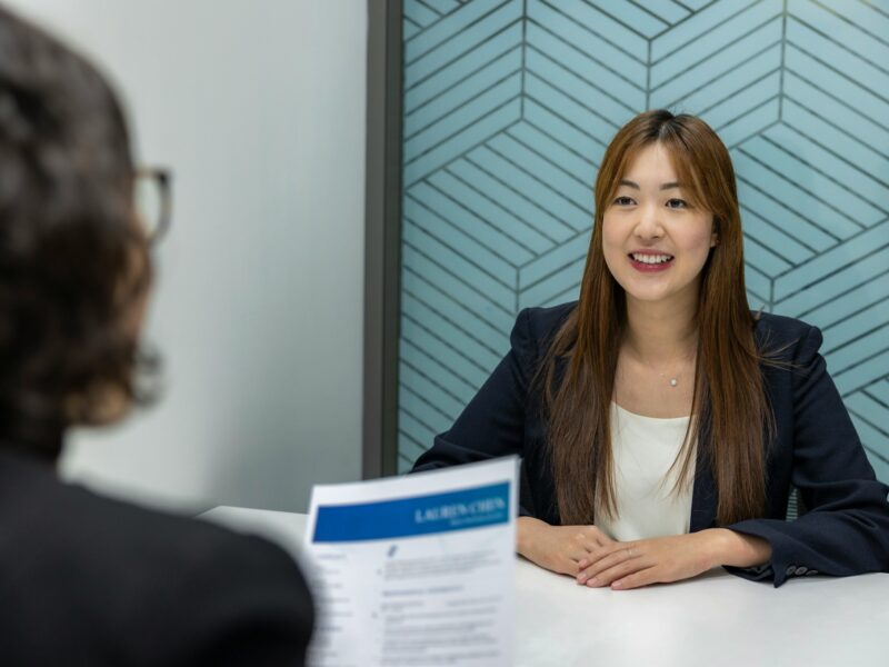a woman sitting at a table with a woman in front of her