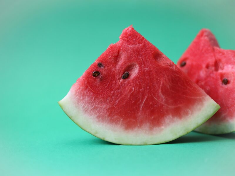 a watermelon wedges on a blue background